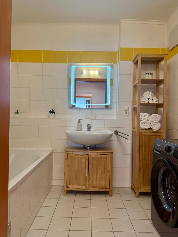 Bathroom with mirror and washing machine Apartment D01