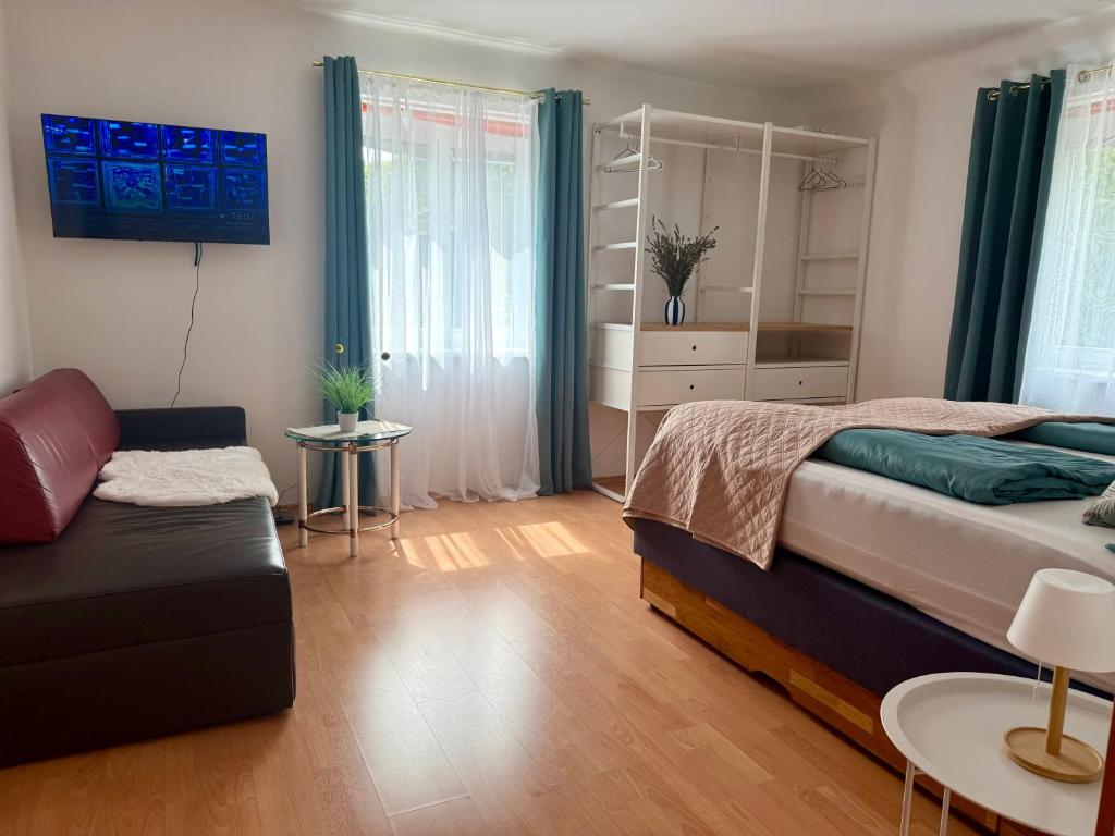 Bedroom with TV and sofa Apartment D01