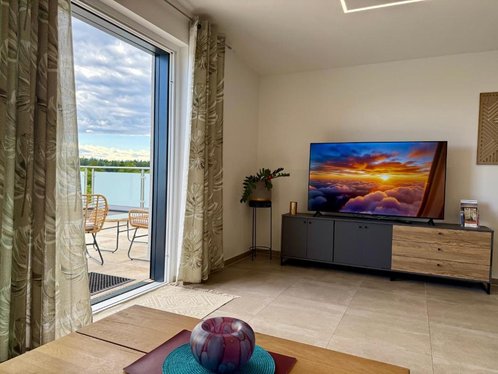 Living room with TV and balcony Top 1